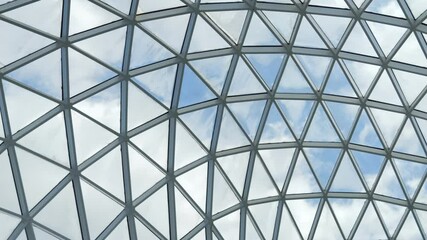 Large, clear dome with a blue sky above it. The dome is made of glass and has a triangular shape