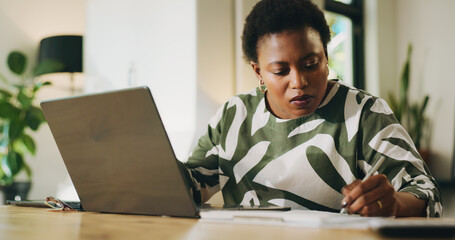 Remote work from home, writing and black woman with laptop, creativity and planning. African...