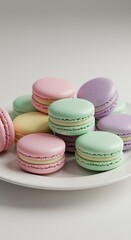 Obraz premium Pastel Macarons on White Plate Sweet Treats Pink Purple Green Yellow