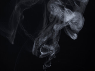 White Smoke Swirls on Black Background for Composite Use
