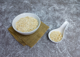 Oat flakes or rolled oats in a white bowl