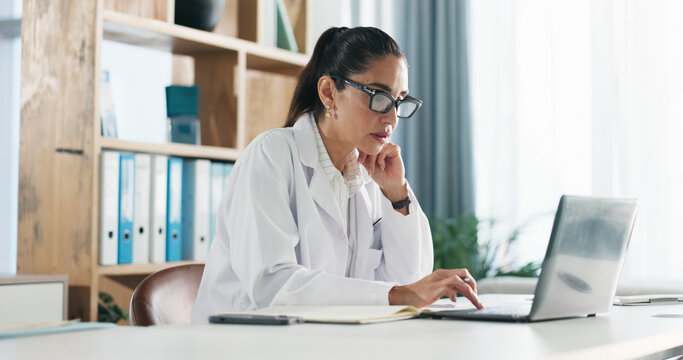Research, woman and doctor with laptop in hospital for medical report or diagnostic information. Thinking, computer and female healthcare worker with brainstorming for treatment plan in clinic office