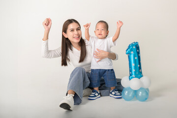 Celebration of a Child’s First Birthday With a Joyful Mother and Her Happy Toddler