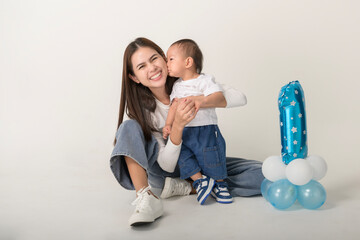 Celebration of a Child’s First Birthday With a Joyful Mother and Her Happy Toddler