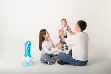 Family Poses Together in a Studio Portrait With Joyful Smiles and Playful Atmosphere