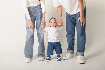 Family Poses Together in a Studio Portrait With Joyful Smiles and Playful Atmosphere