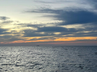 landscape on the sea and horizon with clouds at sunset