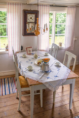 Table and chairs with table settings for coffee in an old cottage