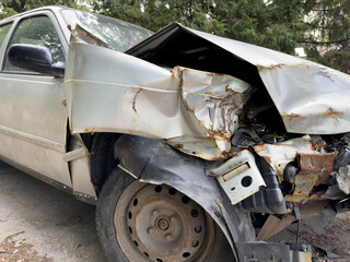 Close up of severely damaged vehicle involved in road accident, showing extensive structural damage...