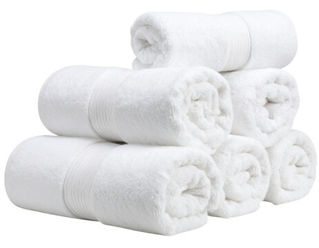 Six neatly rolled white towels stacked in a pyramid arrangement.