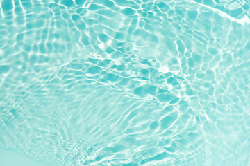Blue water with ripples on the surface. Defocus blurred transparent blue colored clear calm water...