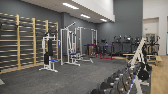 Compact gym filled with powerful multi-functional exercise machines for intense targeted full-body workouts. Clean well-organized space