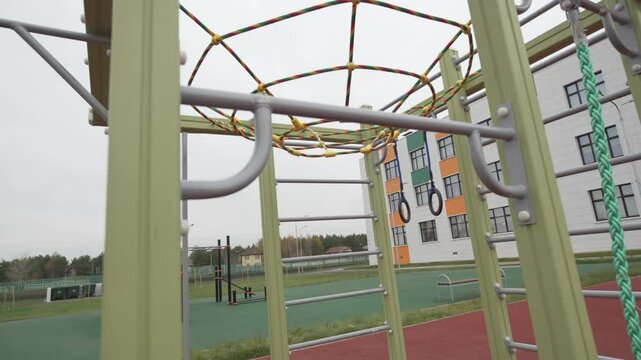 Rugged pull-up structure with ladders supports outdoor strength along with endurance exercises. Metal frames withstand weather and pressure