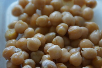A close-up of golden-hued dried chickpeas, artfully arranged to highlight their rustic texture and natural warmth. A quiet tribute to this humble ingredient, a staple across many world cuisines.