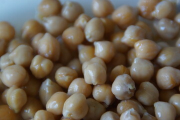A close-up of golden-hued dried chickpeas, artfully arranged to highlight their rustic texture and natural warmth. A quiet tribute to this humble ingredient, a staple across many world cuisines.
