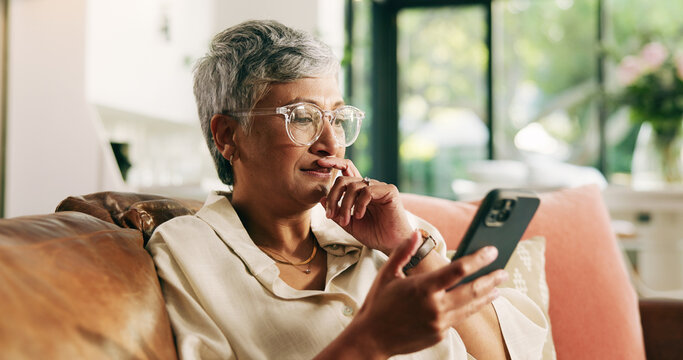 Mature woman, phone and sofa in home with thinking, texting and reading notification on web. Person, smartphone and decision with mobile app, search and post on social media on couch at apartment