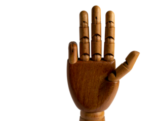 Wooden mannequin in mid-air, arms and legs outstretched, isolated on white background.
