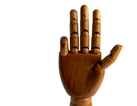 Wooden mannequin in mid-air, arms and legs outstretched, isolated on white background.