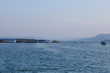 Tranquil seascape with fishing boats and coastal village