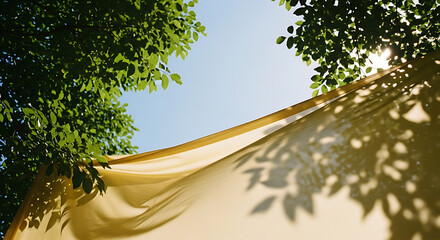Golden fabric canopy with dappled leaf shadows under a clear blue sky and lush green foliage.