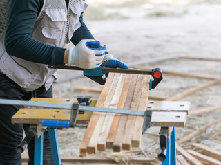 Carpenter Clamping Wooden Planks for Outdoor Woodworking Proje