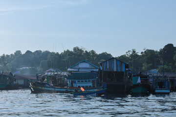 Fishing boats moored at a waterfront village in southeast asia