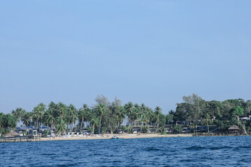 Tropical island beach resort with palm trees and clear blue ocean
