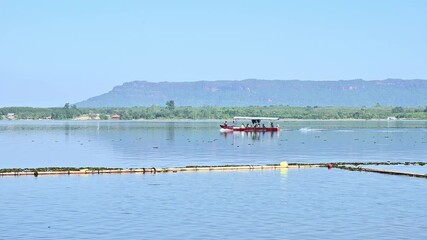 Tourist boat sail in Bueng Khong Long the largest frehwater reservoir in Bueng Kan province of Thailand. This place has been registered as the World's Wetland of International Importance number 1,098.