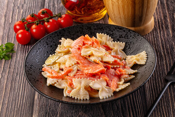 Italian pasta farfalle with salmon