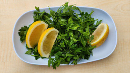 Slices of lemon and a plate of fresh parsley are the timeless companions of Adana kebab, adding...