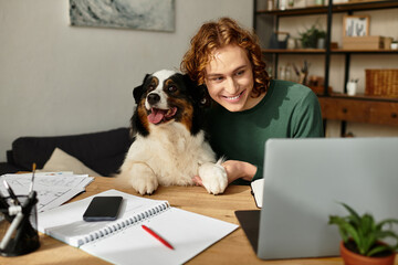 Young man enjoys cozy moments at home with his dog while working on his laptop
