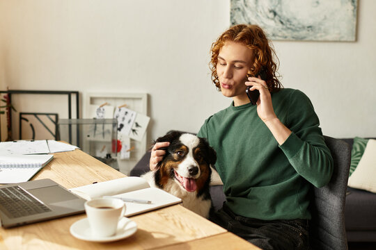 Young man enjoys a cozy afternoon at home while talking on the phone with his dog beside him - Powered by Adobe