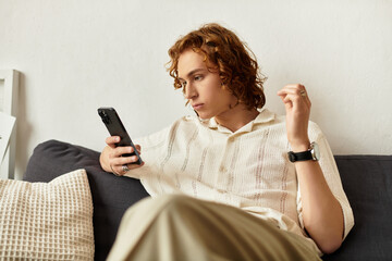 Young man enjoys a cozy moment at home while engaged with his smartphone in a relaxed setting