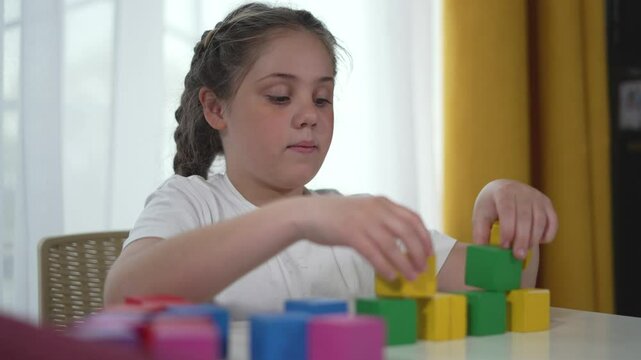 Happy kid kindergarten engaged with colorful blocks. Enjoyable learning child play development. Bright playroom activity happy child with educational toys. Child happy engagement developmental play.