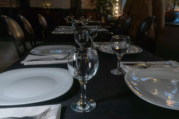 Elegant table setting for a gourmet dinner celebration with fine glassware and stylish cutlery in a modern restaurant ambiance