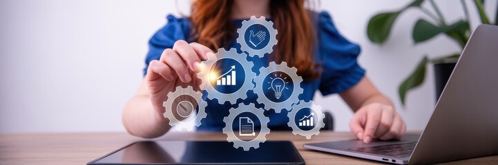 Woman interacting with a holographic interface of interconnected gears.