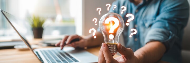 A person holds a lightbulb with question marks around it, suggesting a search for solutions.