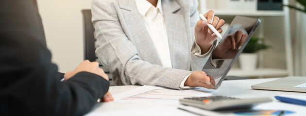 Fototapeta na wymiar Financial consult planning investor asses and present to client, Close up shot client and advisor review investment strategy in the office.