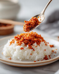 Delicious rice topped with spicy chili paste, showcasing vibrant colors and textures