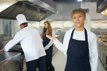 Fototapeta premium portrait young chef showing pose in the kitchen