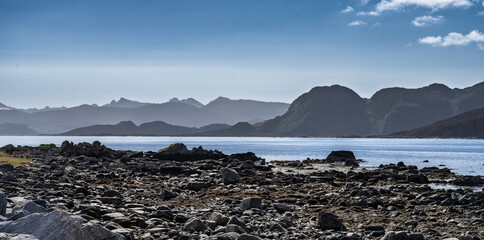 Scenic Coastal View with Mountains and Rocks Under Dramatic Cloudy Sky, Runde, Norway
