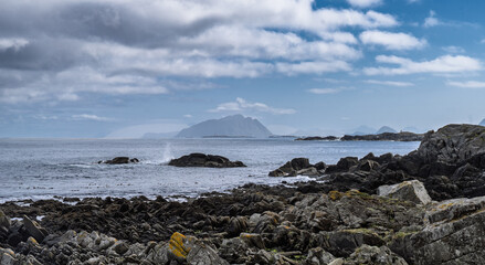 Scenic Coastal View with Mountains and Rocks Under Dramatic Cloudy Sky, Runde, Norway