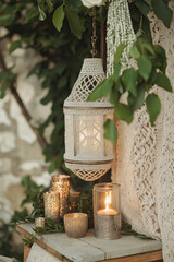 Ornate Moroccan lantern surrounded by flickering candles creates enchanting atmospheric garden lighting.