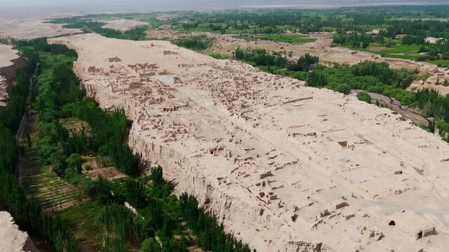 Aerial establishing fly at natural archaeological ruins in Chinese Plateau, Turpan Jiaohe landscape