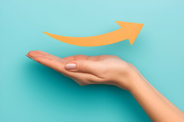 A hand is held palm-up with an orange arrow hovering above, pointing upward against a blue background, symbolizing growth or progress.