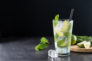 Classic Mojito Cocktail with Lime and Mint on black background. Copy space