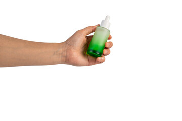 Green glass cosmetic bottle, Skin care or sunscreen cosmetic with hand on transparent background.