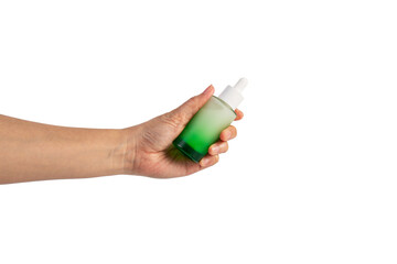 Green glass cosmetic bottle, Skin care or sunscreen cosmetic with hand on transparent background.