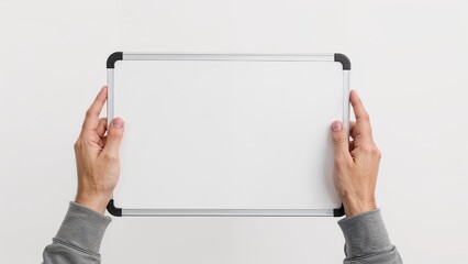 Whiteboard held by hand against white backdrop