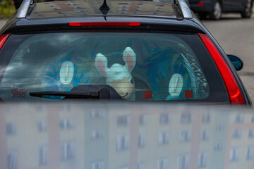 Inflatable toys in the trunk of a car, the car packed for a vacation, returning home